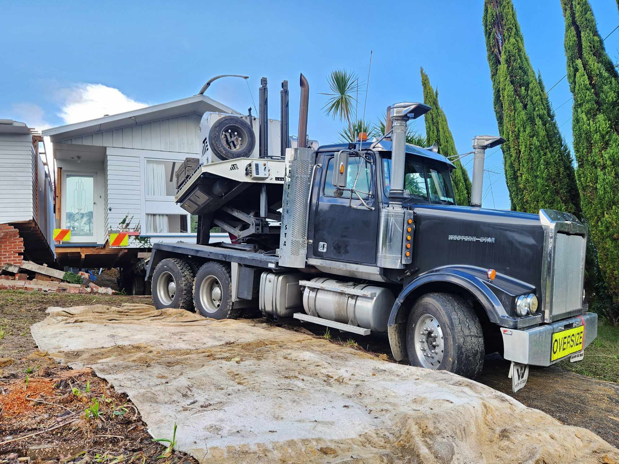 A house being removed from a difficult site by transporter